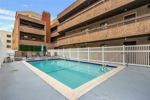 pool featuring a patio area and fence