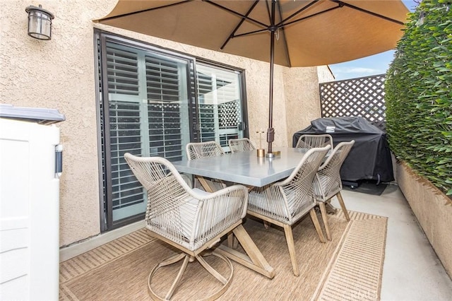 view of patio with outdoor dining space and a grill