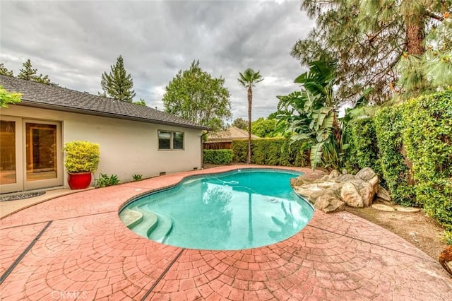 view of pool featuring a patio, a fenced in pool, and a fenced backyard