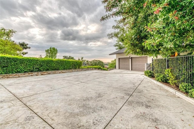 view of patio / terrace featuring a garage and fence