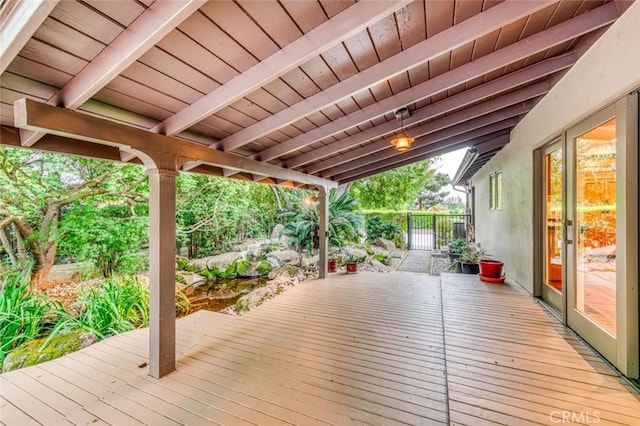wooden deck featuring fence and french doors