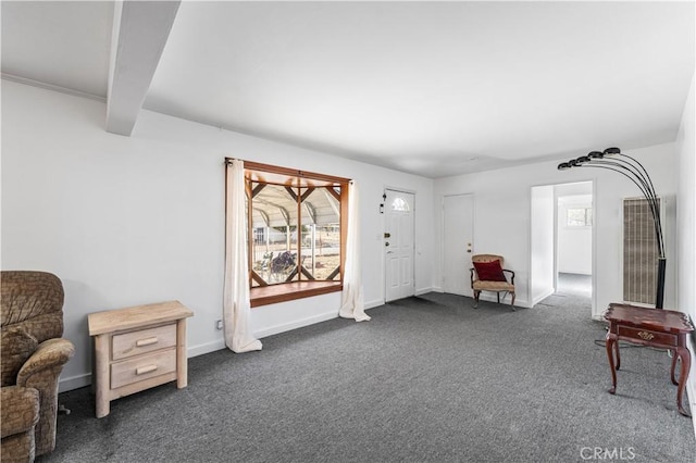 living area with baseboards and dark carpet