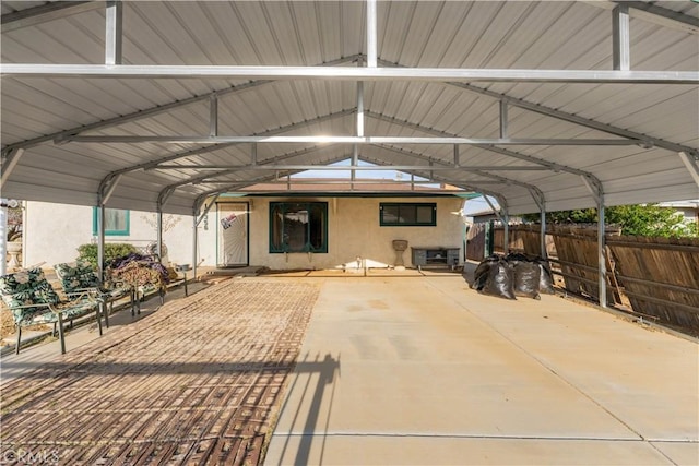 exterior space featuring fence and a detached carport