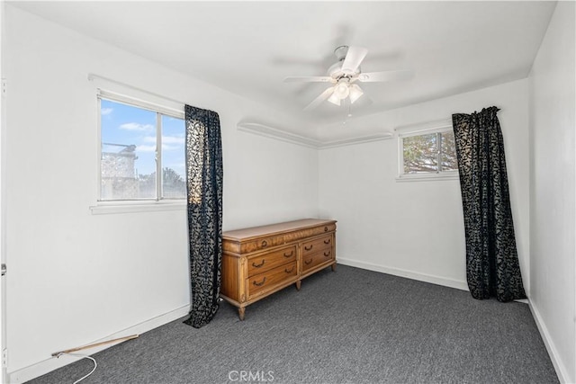 bedroom featuring baseboards, ceiling fan, and dark carpet