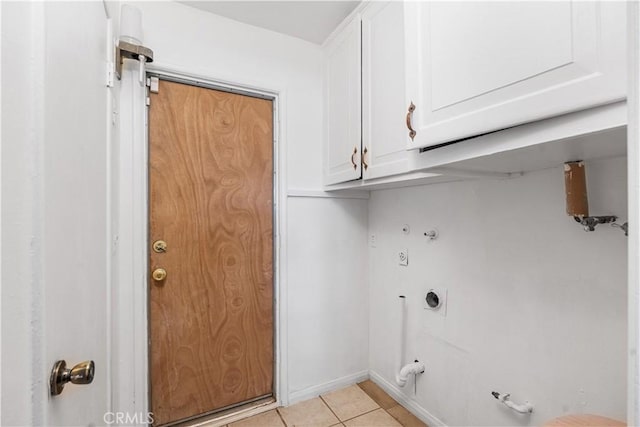 clothes washing area featuring cabinet space, hookup for a gas dryer, and light tile patterned floors