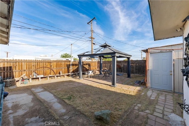 view of yard featuring a fenced backyard, a patio, and a gazebo