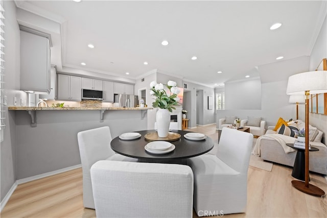 15212 Cambridge St, Tustin, CA 92782 - dining space featuring recessed lighting, ornamental molding, and light wood-style flooring