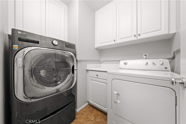 15212 Cambridge St, Tustin, CA 92782 - laundry area featuring light tile patterned flooring, cabinet space, and washing machine and clothes dryer