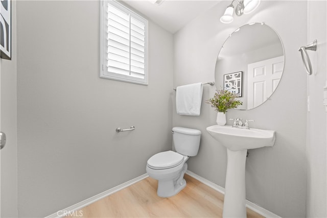 15212 Cambridge St, Tustin, CA 92782 - half bathroom featuring baseboards, toilet, and wood finished floors