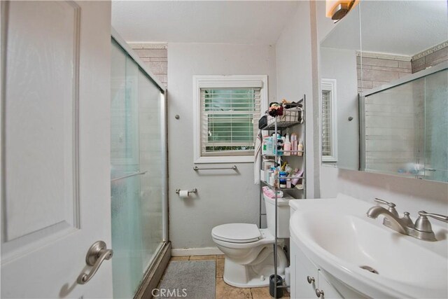 15709 Devonshire St, Granada Hills, CA 91344 - full bath featuring a stall shower, toilet, tile patterned flooring, and baseboards