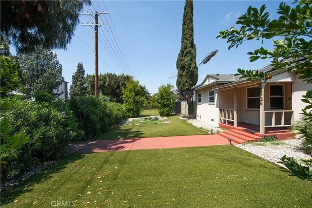 15709 Devonshire St, Granada Hills, CA 91344 - view of grassy yard with a storage unit and an outbuilding