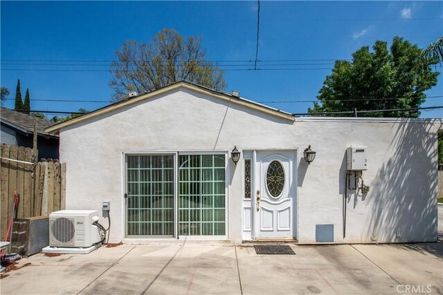 15709 Devonshire St, Granada Hills, CA 91344 - back of house with a cooling unit, a patio area, stucco siding, and fence