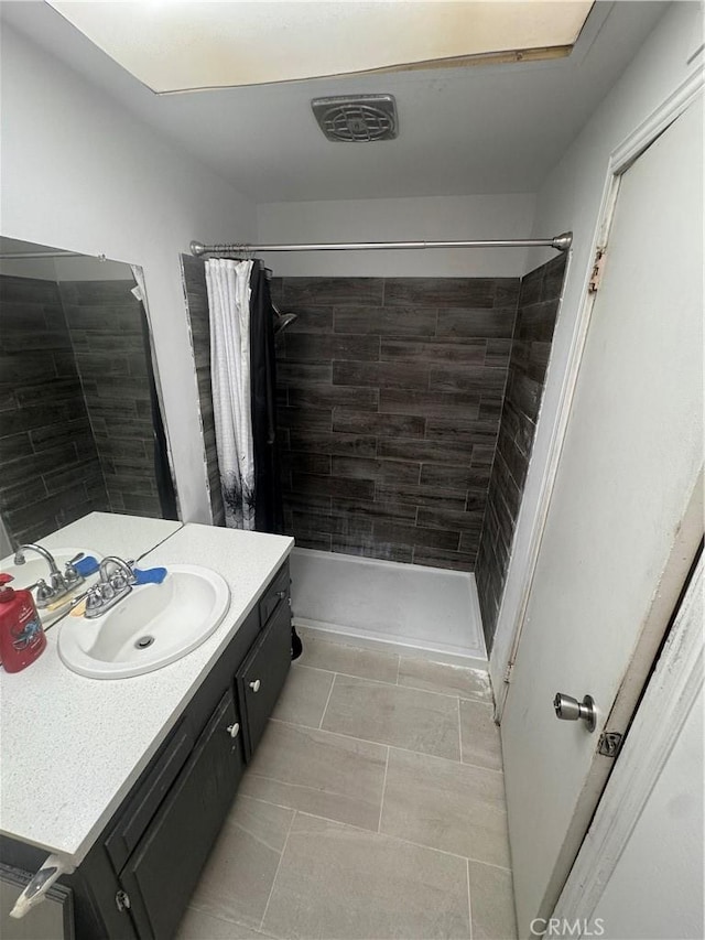 5945 Crystal Hill St, Riverside, CA 92504 - bathroom with vanity, tiled shower, and tile patterned floors
