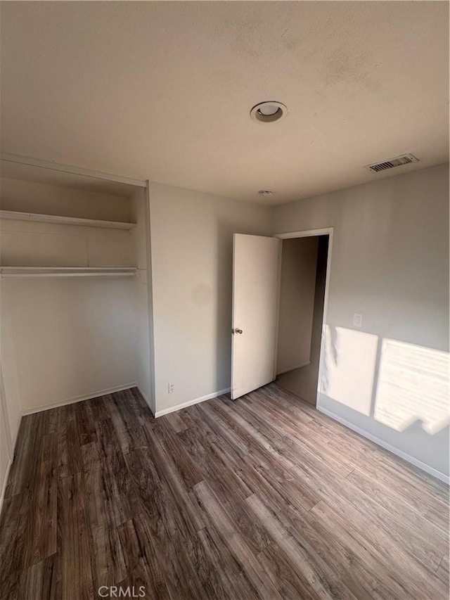 5945 Crystal Hill St, Riverside, CA 92504 - unfurnished bedroom featuring wood finished floors, a closet, and baseboards