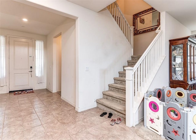 5597 Royal Oaks Way, Fontana, CA 92336 - foyer entrance with stairway, baseboards, and light tile patterned floors