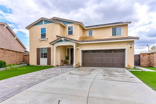 5597 Royal Oaks Way, Fontana, CA 92336 - traditional-style house featuring an attached garage, stucco siding, driveway, roof mounted solar panels, and a gate