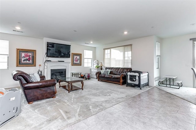 5597 Royal Oaks Way, Fontana, CA 92336 - carpeted living room featuring a glass covered fireplace and recessed lighting