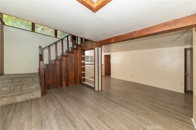 below grade area featuring stairs and wood finished floors
