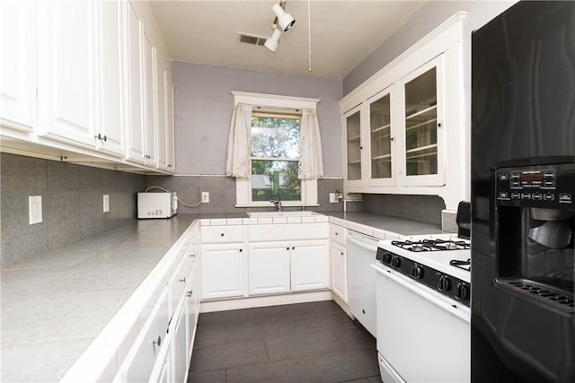 kitchen featuring visible vents, white appliances, glass insert cabinets, white cabinets, and a sink