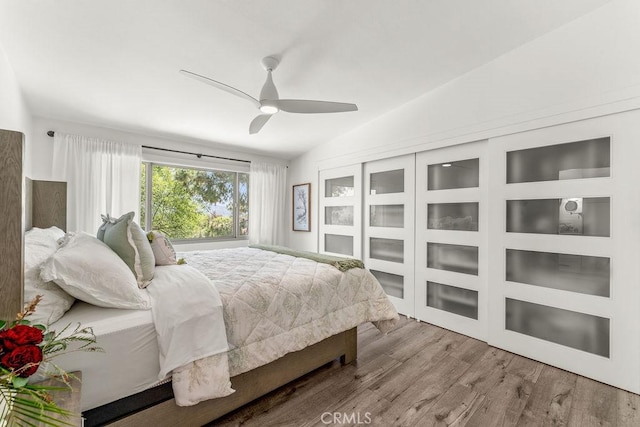 bedroom featuring lofted ceiling, wood finished floors, and ceiling fan