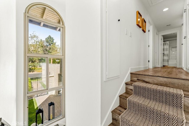 staircase with baseboards, recessed lighting, and wood finished floors
