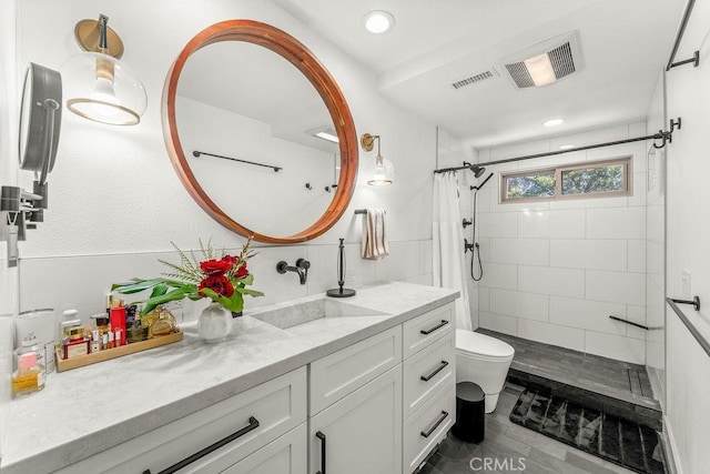 full bath with toilet, visible vents, a tile shower, and vanity