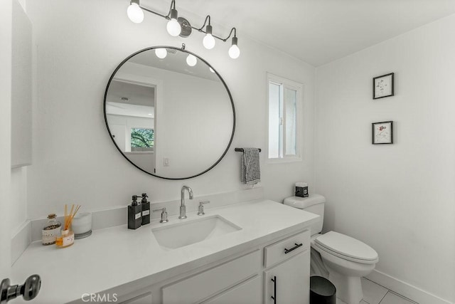 bathroom with vanity, tile patterned flooring, and toilet