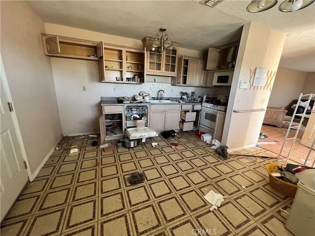kitchen featuring open shelves, a sink, a textured ceiling, white microwave, and gas range oven