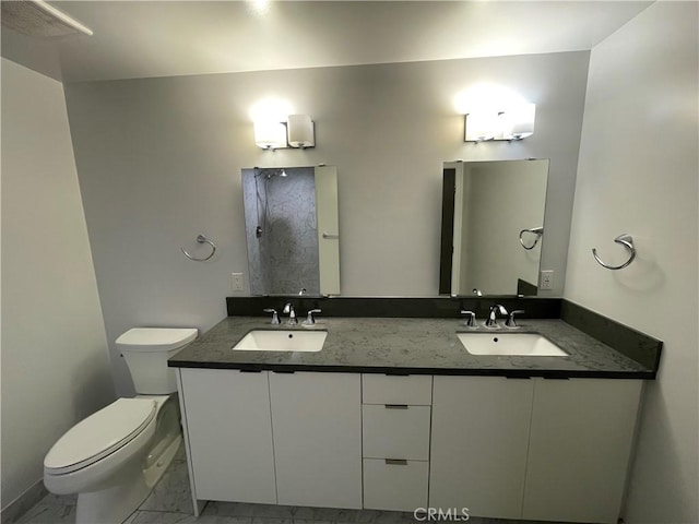 full bathroom featuring a sink, toilet, double vanity, and marble finish floor