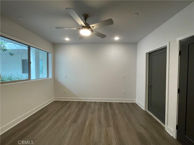 spare room with recessed lighting, baseboards, ceiling fan, and dark wood-style floors