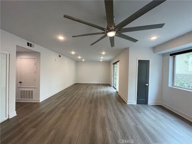 spare room featuring visible vents, baseboards, dark wood-type flooring, recessed lighting, and a ceiling fan