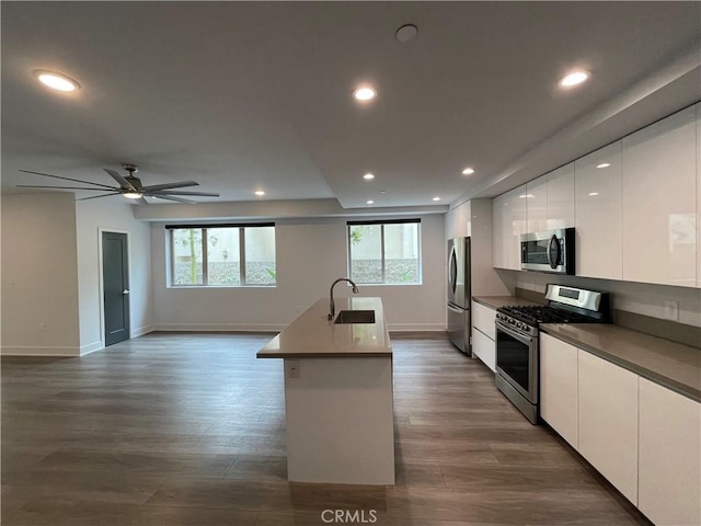 kitchen with white cabinetry, appliances with stainless steel finishes, plenty of natural light, and modern cabinets