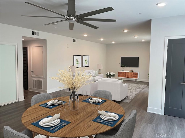 dining space featuring baseboards, ceiling fan, visible vents, and wood finished floors
