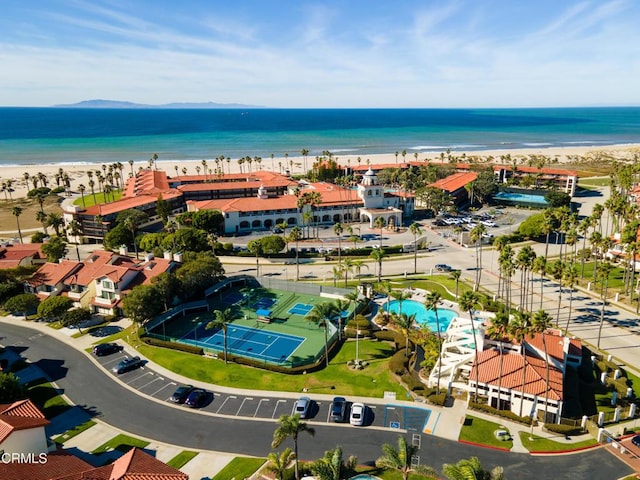 drone / aerial view with a beach view and a water view