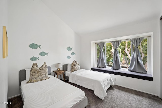 carpeted bedroom with baseboards and vaulted ceiling