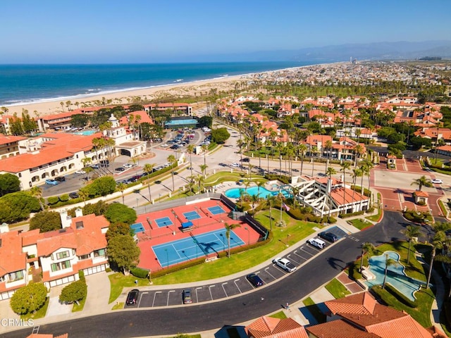 drone / aerial view with a beach view and a water view