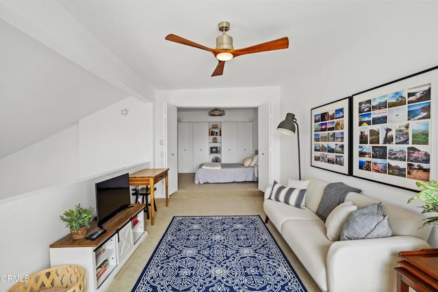 living area with light colored carpet and a ceiling fan