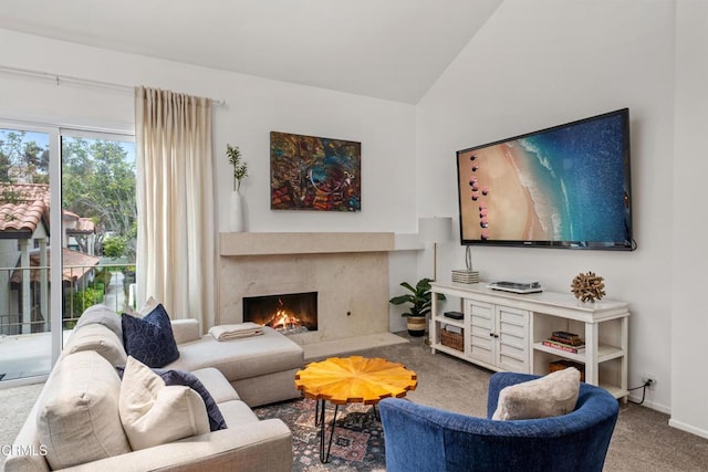 living room with carpet floors, baseboards, vaulted ceiling, and a premium fireplace