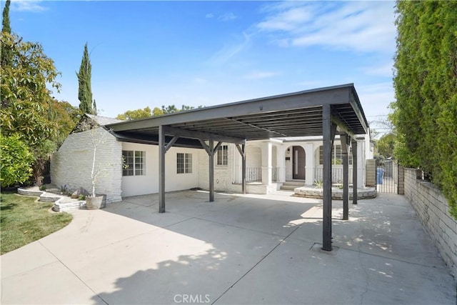 back of property with fence and a detached carport