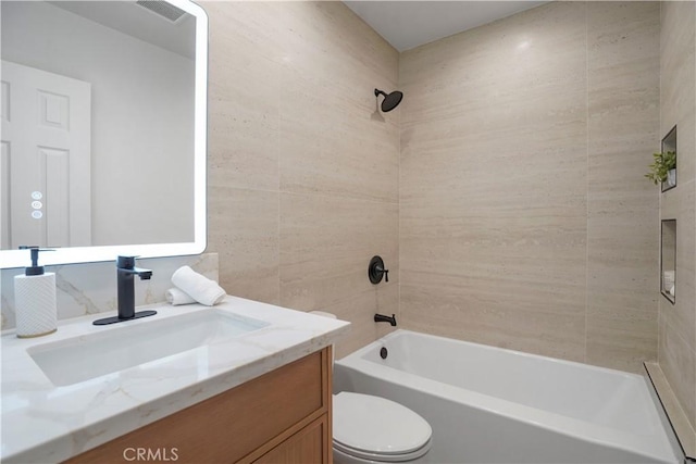 bathroom featuring vanity, toilet, bathing tub / shower combination, and visible vents