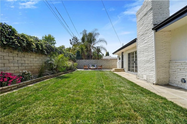 view of yard featuring a patio and a fenced backyard