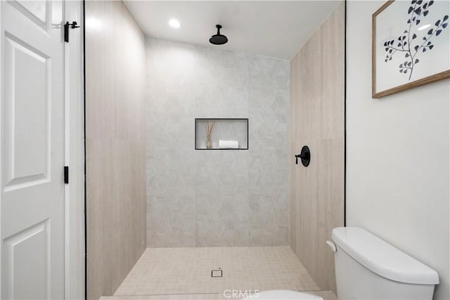 full bathroom with toilet and tiled shower