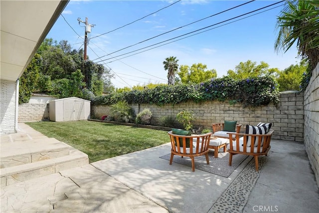 view of patio with outdoor lounge area, an outbuilding, a fenced backyard, and a storage unit