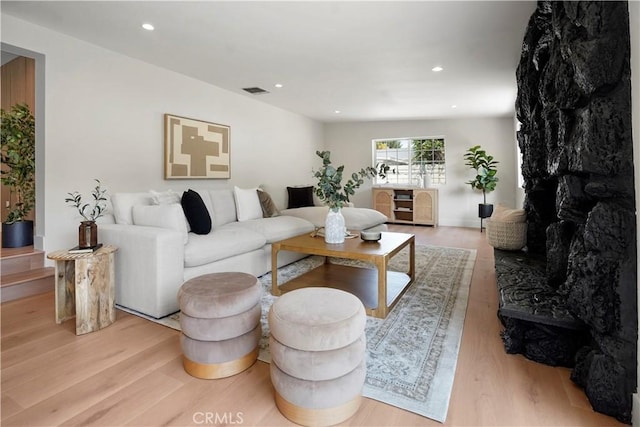 living area featuring recessed lighting, wood finished floors, and visible vents