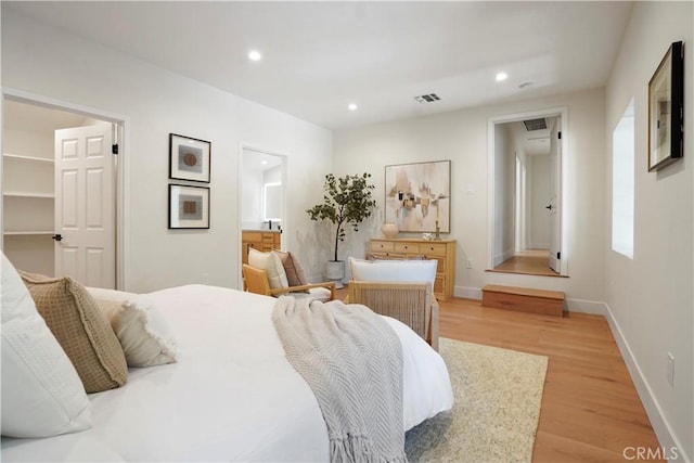 bedroom with recessed lighting, baseboards, visible vents, and light wood finished floors