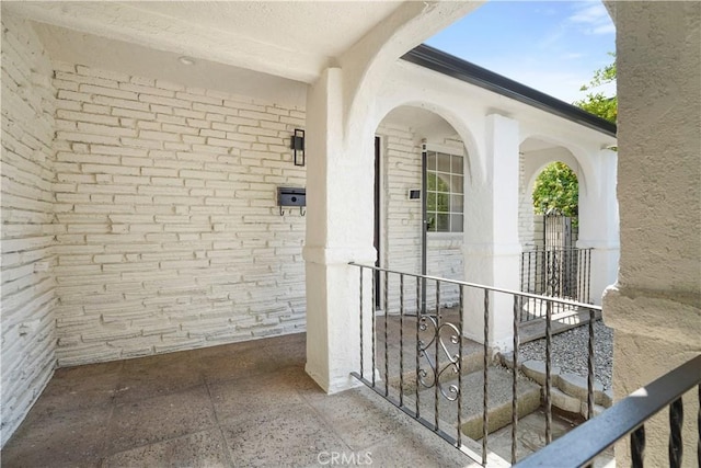 view of exterior entry with brick siding