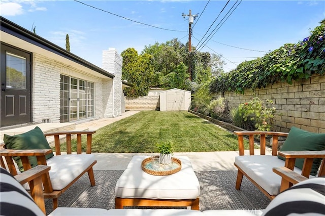 view of yard with an outdoor structure, a fenced backyard, a shed, and a patio