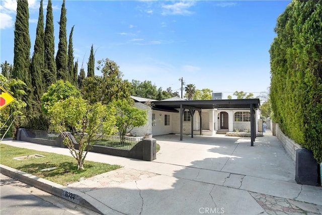 view of front facade featuring fence private yard and concrete driveway