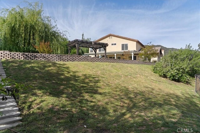 view of yard with a pergola and fence