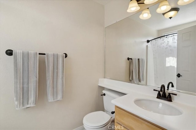bathroom with vanity, baseboards, toilet, and curtained shower